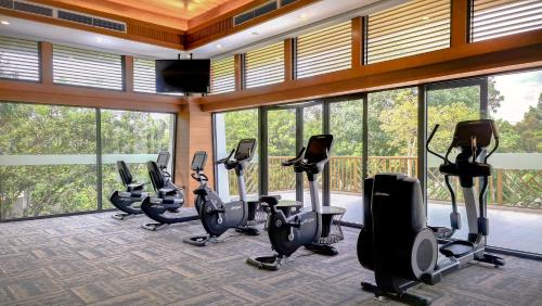 a gym with a bunch of exercise bikes in a room at Wyndham Grand Phu Quoc in Phu Quoc