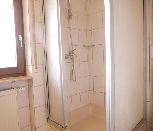 a shower with a glass door in a bathroom at Gasthaus Engel in Bühlertal