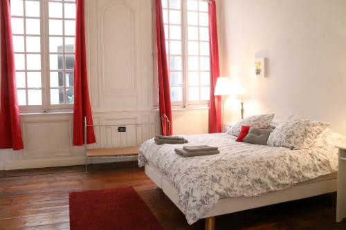 a bedroom with red curtains and a bed with a red rug at Key to Bordeaux - fairytale view, 2 bd + elevator in Bordeaux