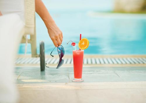 a person preparing a drink on a table at Holiday Inn Dhaka City Centre by IHG in Dhaka