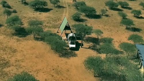 an aerial view of a small house in a field at Ovita Wildlife Restcamp in Okazize