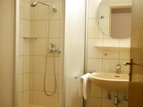 a bathroom with a shower and a sink at Gasthaus Engel in Bühlertal