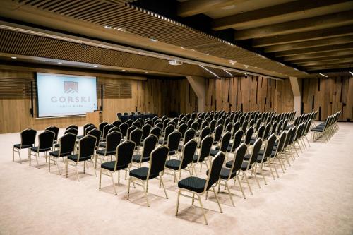 an empty room with chairs and a screen in it at Gorski Hotel & Spa in Kopaonik