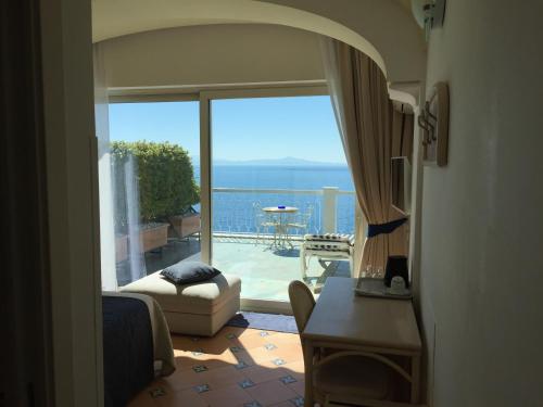 a living room filled with furniture and a window at Hotel Bellevue Suite in Amalfi