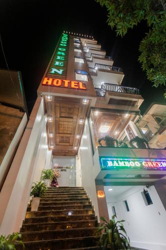 a hotel with stairs leading up to it at night at Bamboo Green Hotel in Dong Hoi