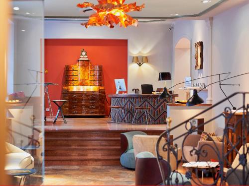 a store lobby with a counter and a chandelier at Boutique Hotel & Villa AUERSPERG in Salzburg