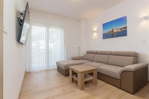 a living room with a couch and a table at Vila Vita Apartments in Kranjska Gora