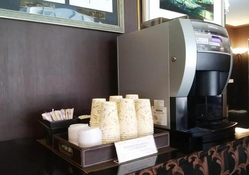a coffee maker and a pile of paper towels at Hotel Okus in Kumamoto