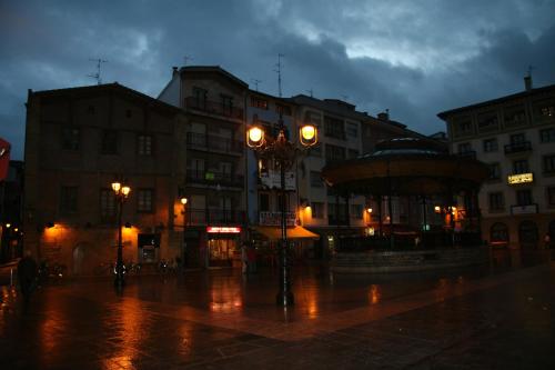 a city street in the rain at night at Ekia Pentsioa in Zarautz