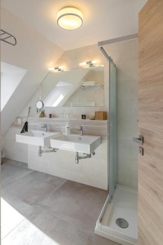 a bathroom with three sinks in a room at Vila Vita Apartments in Kranjska Gora