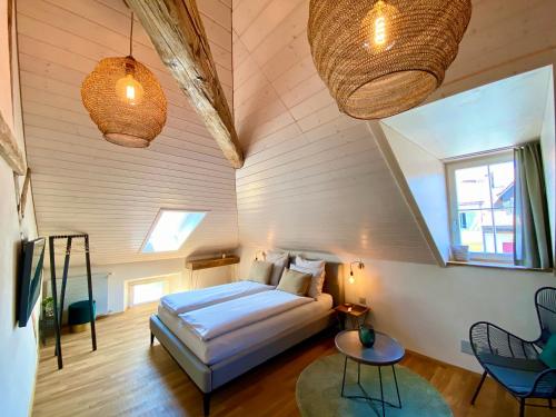 a bedroom with a bed in a room with wooden ceilings at Zimmerei in Murten