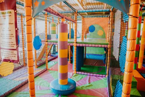a playground with a play structure with aoc at Bowfield Hotel and Spa in Howwood
