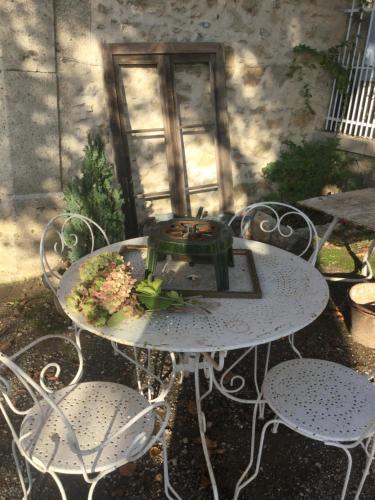 a white table with chairs and a plant on it at Chez Les Brocs B&B in Canet d'Aude