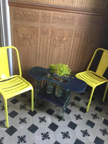 two yellow chairs and a table with a plant on it at Chez Les Brocs B&B in Canet d'Aude