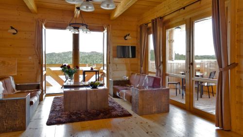 a living room with a couch and a table at Ostoja Spokoju in Olchowiec