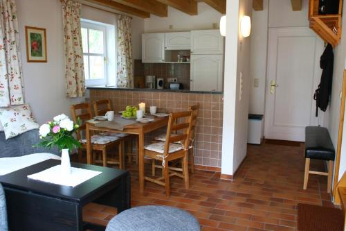 a kitchen and living room with a table and chairs at Ferienhaus Seegasse 4 in Göhren-Lebbin