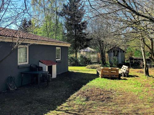 a house with a picnic table and a bench in the yard at 8 person holiday home in rsted in Kare