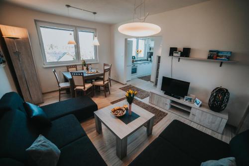 a living room with a couch and a table at Apartmán Tatranská Lomnica in Tatranská Lomnica