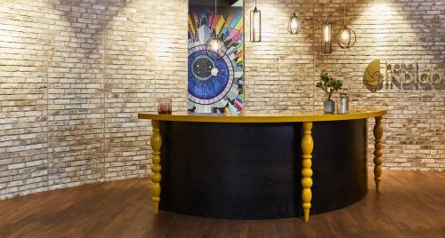 
a wooden table in a room with a painting on the wall at Hotel Indigo Berlin - East Side Gallery, an IHG Hotel in Berlin
