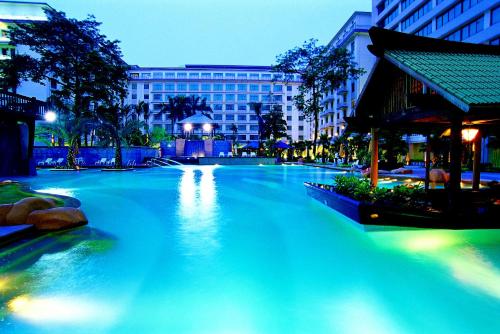 
a large swimming pool in the middle of a city at Dong Fang Hotel Guangzhou in Guangzhou
