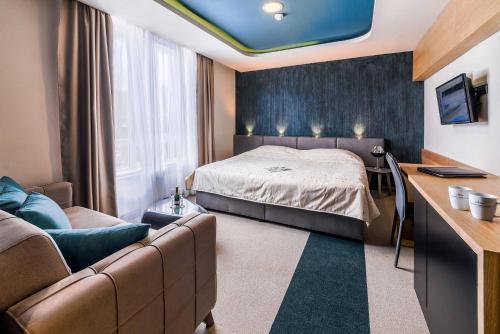 Habitación de hotel con cama y sofá en Hotel Kraljevi Čardaci en Kopaonik