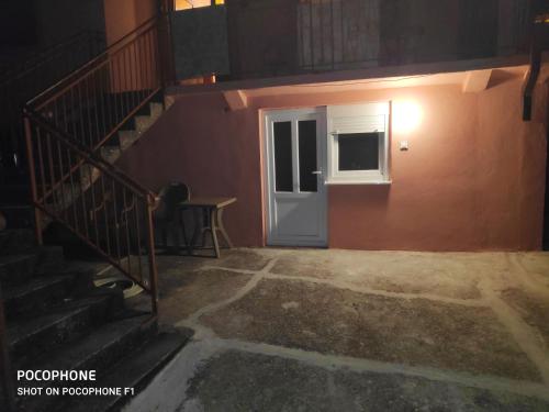 a staircase leading to a door in a building at Apartman Pavle 2 in Virpazar