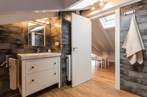 a bathroom with a sink and a mirror at El Balcon De La Lomba in La Lomba