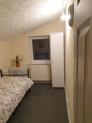 a bedroom with a bed and a window and a door at Chatham Private Rooms in Chatham