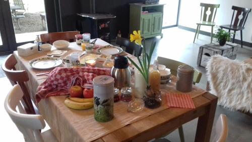 a wooden table with food and fruit on it at De Hostee in Stolwijk