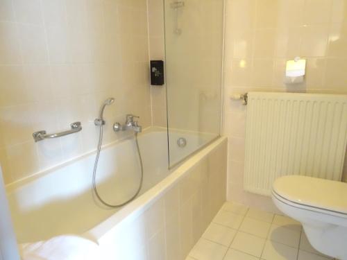 a bathroom with a shower and a toilet at Value Stay Blankenberge in Blankenberge