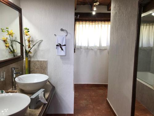 a bathroom with a sink and a toilet and a tub at Villa San Jose Hotel & Suites in Morelia