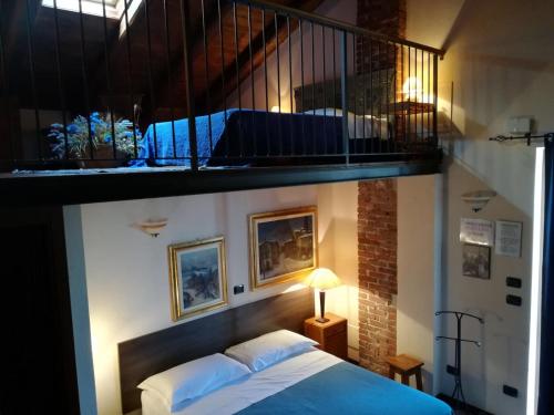 a bedroom with a bed under a stair case at B&B Gira-Sole in Cuneo