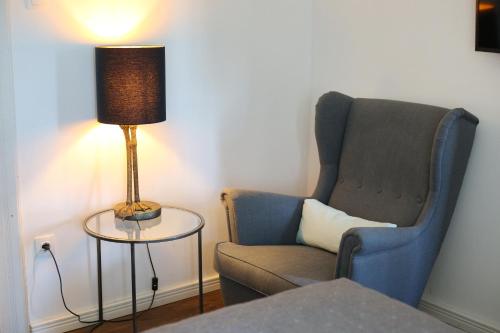 a living room with a chair and a lamp at Vánkos in Badacsonyörs