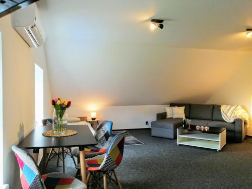 a living room with a table and chairs and a couch at Penzion Drnovec in Cvikov