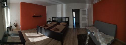 a living room with a couch and orange walls at Ubytování s vyhlídkou in Český Krumlov