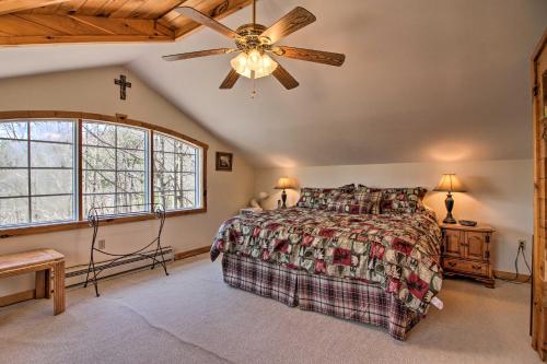 a bedroom with a bed and a ceiling fan at Spacious Mtn Cabin on 7 Private Acres in Athol! in Athol