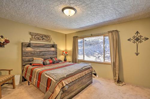 a bedroom with a bed and a large window at Hills City Hideaway 12 Miles to Mt Rushmore! in Hill City