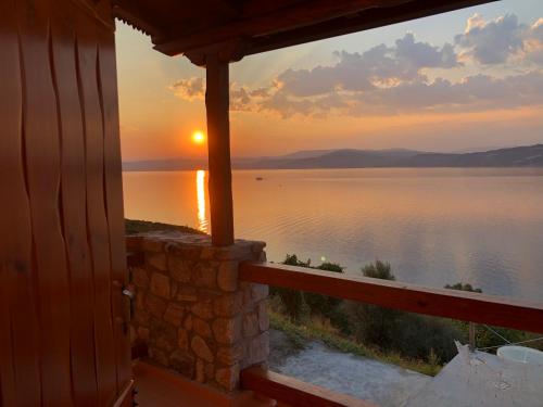 a sunset seen from a window of a cabin at Ammou Area in Ammouliani