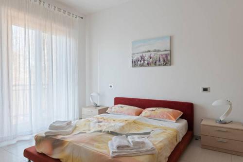 a bedroom with a bed with towels on it at Modern and new apartment in Brianza in Vimercate