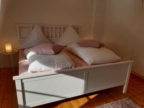 a bed with two pillows on top of it at Cafe-Konditorei-Pension Sander in Niederfell