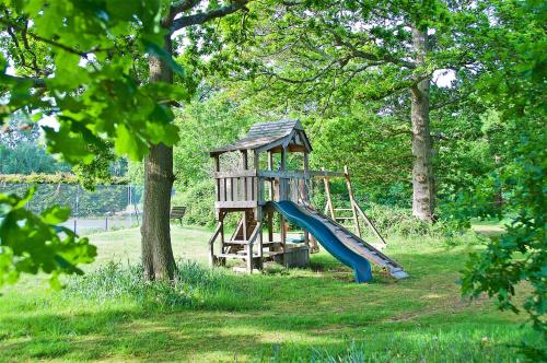 a playground with a slide in a park at Northlands Farm Superior Chalet 1 in Chichester