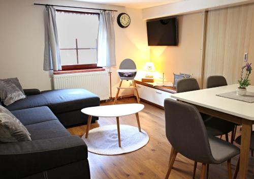 a living room with a couch and a table at Ubytování pod Rozhlednou in Velké Karlovice