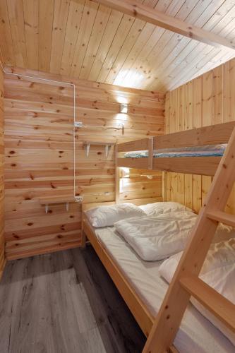 a wooden cabin with two bunk beds in it at Birkelund camping in Geilo