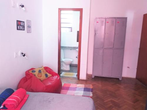 a small room with a refrigerator and a bed at Rock! and Hostel in Belo Horizonte