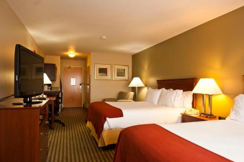 a hotel room with two beds and a flat screen tv at Holiday Inn Express Walla Walla by IHG in Walla Walla