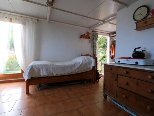 a bedroom with a bed and a clock on the wall at FREEDOM in Tablado de la Montañeta