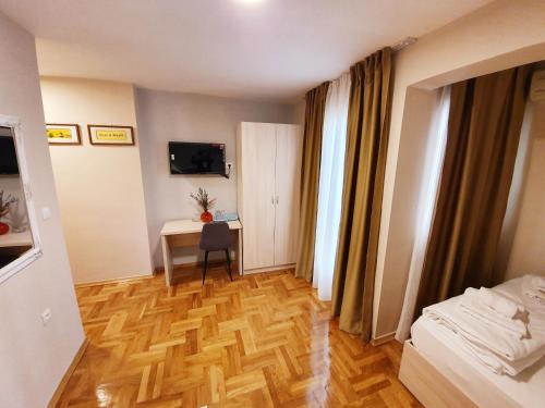 a bedroom with a desk and a bed and a table at Apartments Pier in Budva
