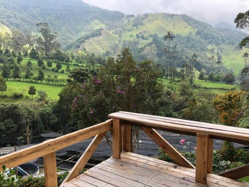 a wooden deck with a view of a mountain at Cabañas Valle del Cocora La Truchera in Salento