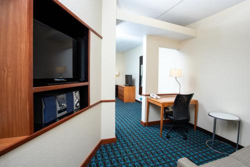 a living room filled with furniture and a tv at Quality Inn & Suites in Sandusky