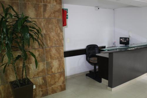 an office with a desk and a potted plant at Hospedaje Sary House in Bogotá